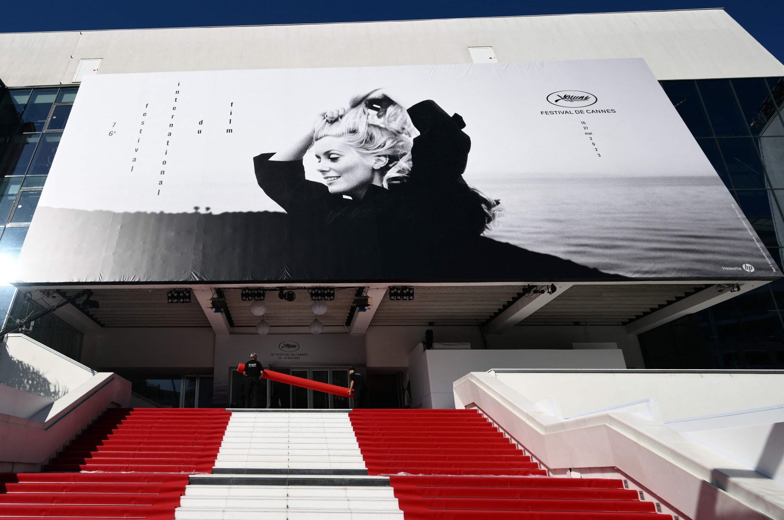 Workers prepare the red carpet ahead of the opening of the 76th Cannes Film Festival in Cannes, France, May 16, 2023. (AFP Photo)