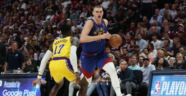 Denver Nuggets' Nikola Jokic (R) drives to the basket against Los Angeles Lakers' Dennis Schroder during the third quarter in game one of the Western Conference Finals at Ball Arena, Denver, US., May 16, 2023. (AFP Photo)