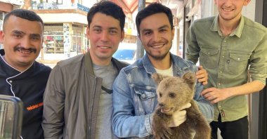 Joyful residents with a bear cub found in a neighborhood in Giresun, Türkiye, May 17, 2023. (AA Photo)