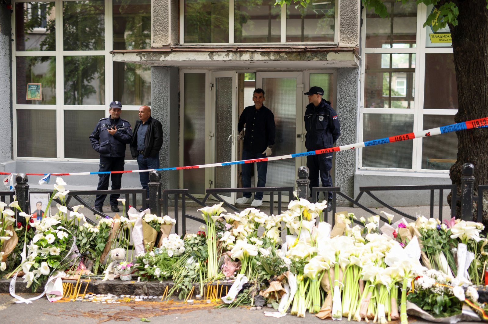 Police officers stand in front of the school where a mass shooting took place, after a boy opened fire on others, killing fellow students and staff in Belgrade, Serbia, May 4, 2023. (Reuters Photo)
