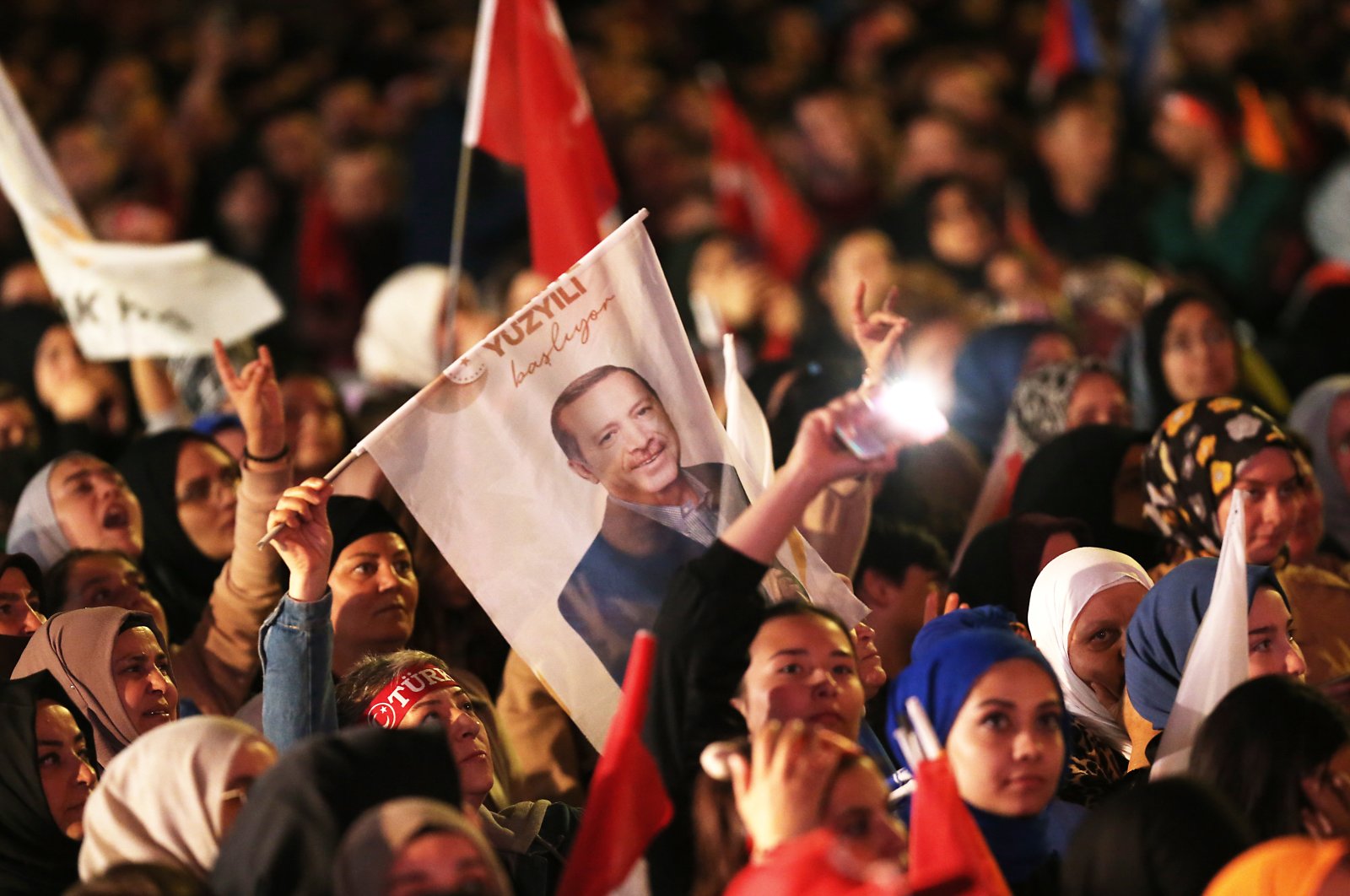Supporters wave flags and banners as President Recep Tayyip Erdoğan as he makes an address at the Justice and Development Party (AK Party) headquarters, in Ankara, Türkiye, May 15, 2023. (EPA Photo)