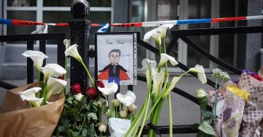 A drawing of security guard Dragan Vlahovic, who was killed in the attack, hangs on the fence of the Vladislav Ribnikar elementary school in the capital Belgrade, Serbia, May 4, 2023. (AFP Photo)