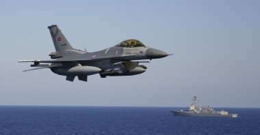 A Turkish F-16 fighter flies over naval ships during an annual NATO naval exercise on Türkiye's western coast on the Mediterranean, Sept. 15, 2022. (AP Photo)