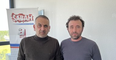 İsmail Erel (L) and Cemil Albay speak to reporters after their release, in Frankfurt, Germany, May 17, 2023. (AA Photo)