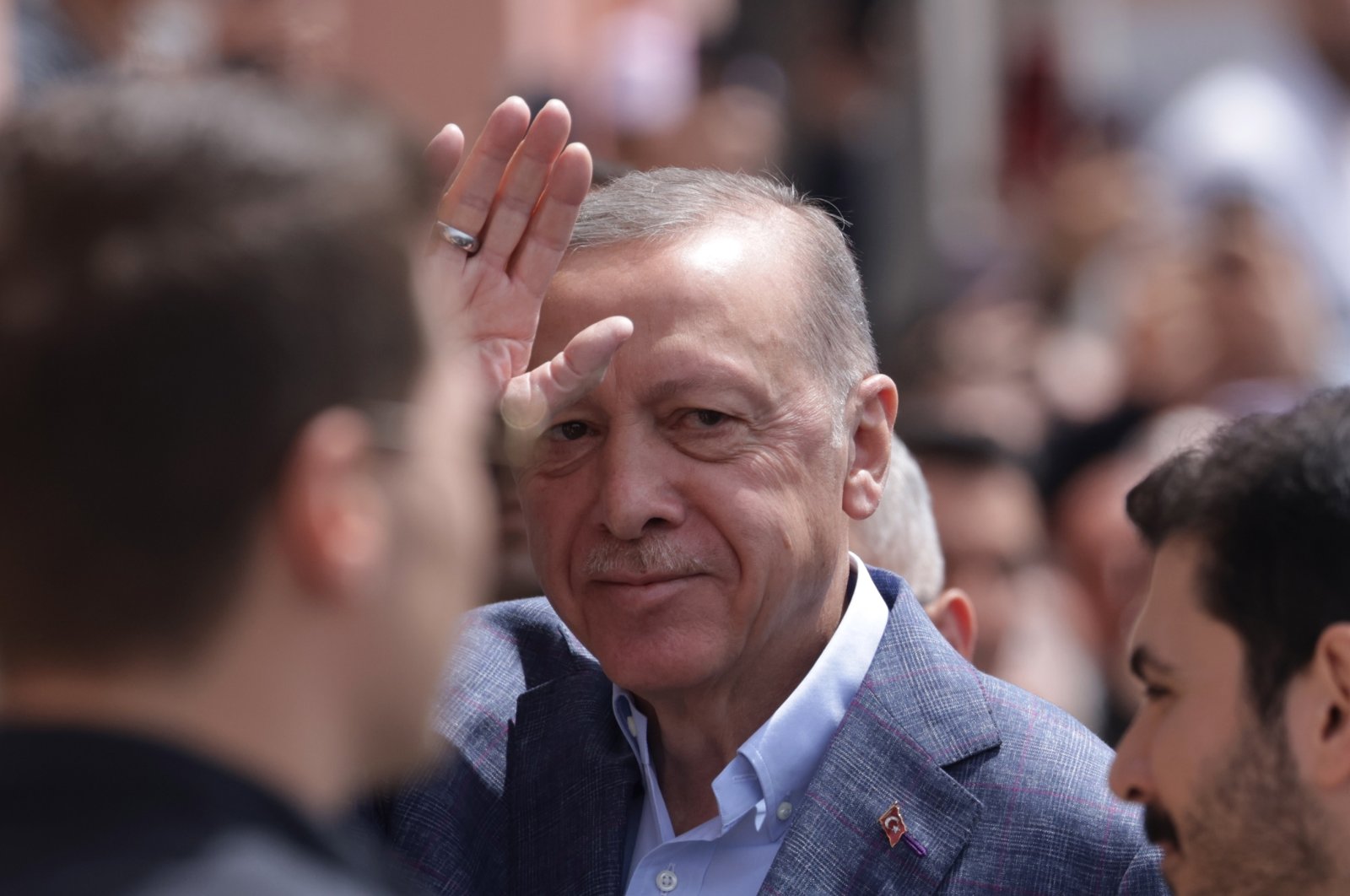President Recep Tayyip Erdoğan greets his supporters before he votes for the general elections, at a polling station in Istanbul, Türkiye, 14 May 2023 (EPA Photo)