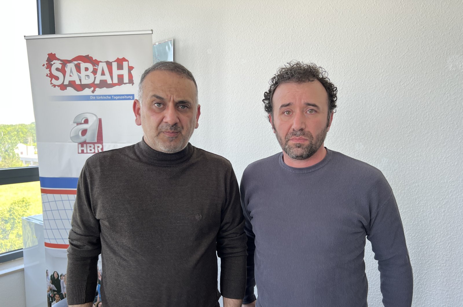 İsmail Erel (L) and Cemil Albay speak to reporters after their release, in Frankfurt, Germany, May 17, 2023. (AA Photo)