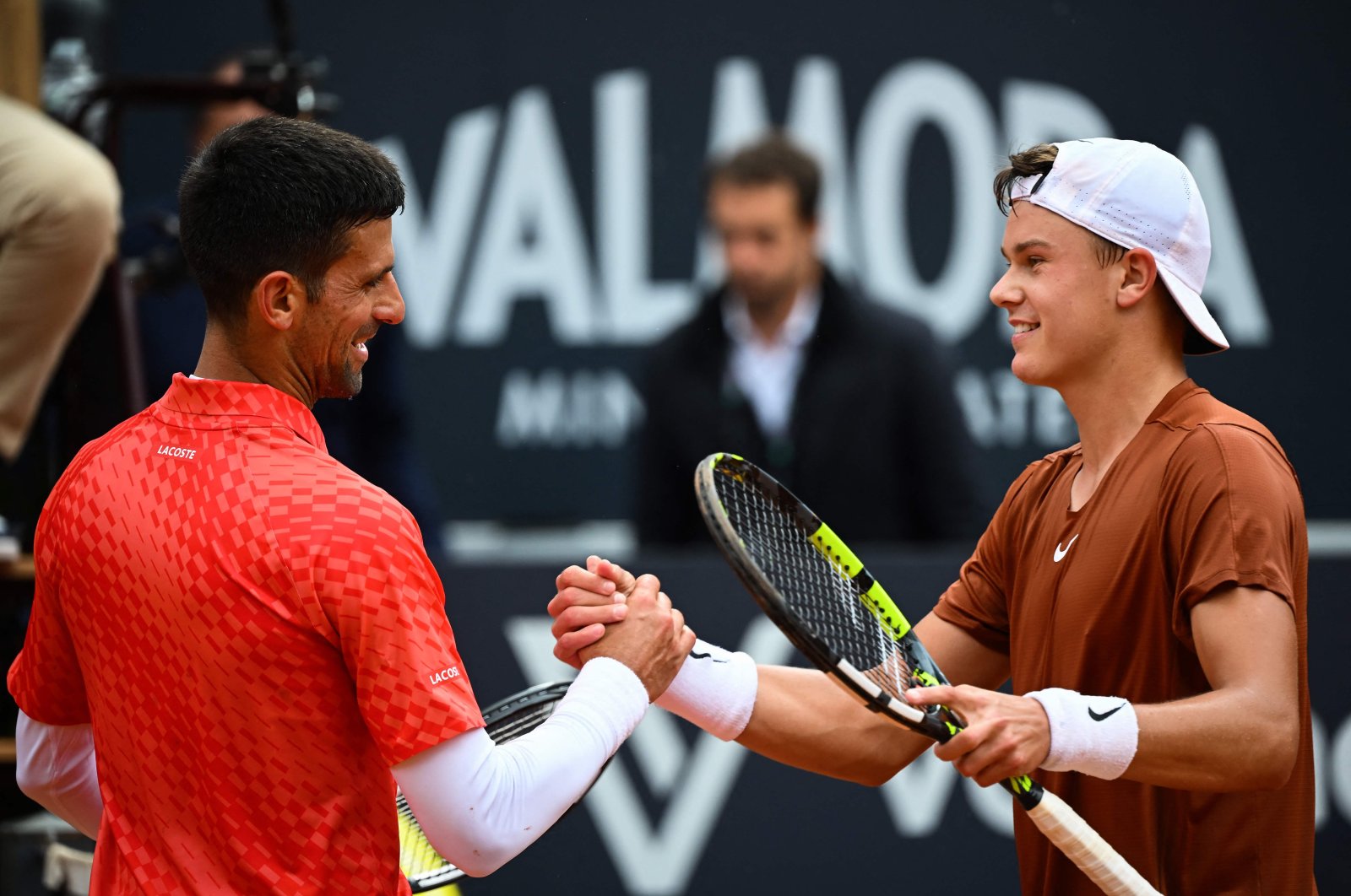 Denmark&#039;s Holger Rune (R) and Serbia&#039;s Novak Djokovic shake hands after Rune won their quarterfinals match of the Men&#039;s ATP Rome Open tennis tournament at Foro Italico, Rome, Italy., May 17, 2023. (AFP Photo)