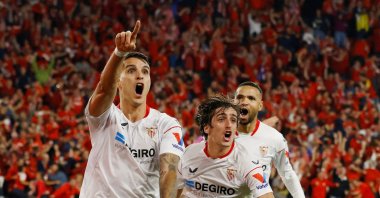 Sevilla's Erik Lamela (L) celebrates scoring their second goal with Bryan Gil (C) and Youssef En-Nesyri against Juventus during Europa League semifinal second leg match at the Ramon Sanchez Pizjuan, Seville, Spain, May 18, 2023. (Reuters Photo)  