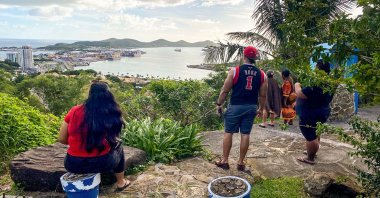 People look out toward the seafront from the Vierge du Pacifique in Noumea, May 19, 2023. (AFP Photo)