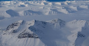 An aerial view shows snowcapped mountains of the arctic landscape near Longyearbyen, Svalbard, Norway, April 5, 2023. (Reuters Photo)