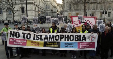 People hold up a banner during a 'Unity Vigil' against racism and Islamophobia in reaction to Wednesday's attack, backdropped by the gates of Downing Street in London, Friday, March 24, 2017. (AP File Photo)