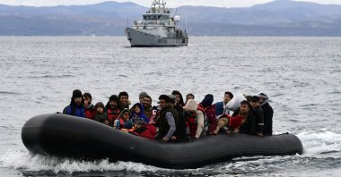 Migrants arrive with a dinghy accompanied by a Frontex vessel at the village of Skala Sikaminias, on the Greek island of Lesbos, after crossing the Aegean Sea from Türkiye, on Feb. 28, 2020. (AP File Photo)