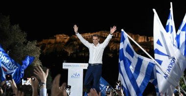 Greek Prime Minister and leader of the conservative New Democracy party Kyriakos Mitsotakis gestures as he addresses his party&#039;s supporters with the Acropolis hill in the background, in Athens, Greece, May 19, 2023. (AFP Photo)