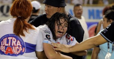 A woman is held by others as she cries following a stampede at a football match, San Salvador, El Salvador, May 20, 2023. (AFP Photo)