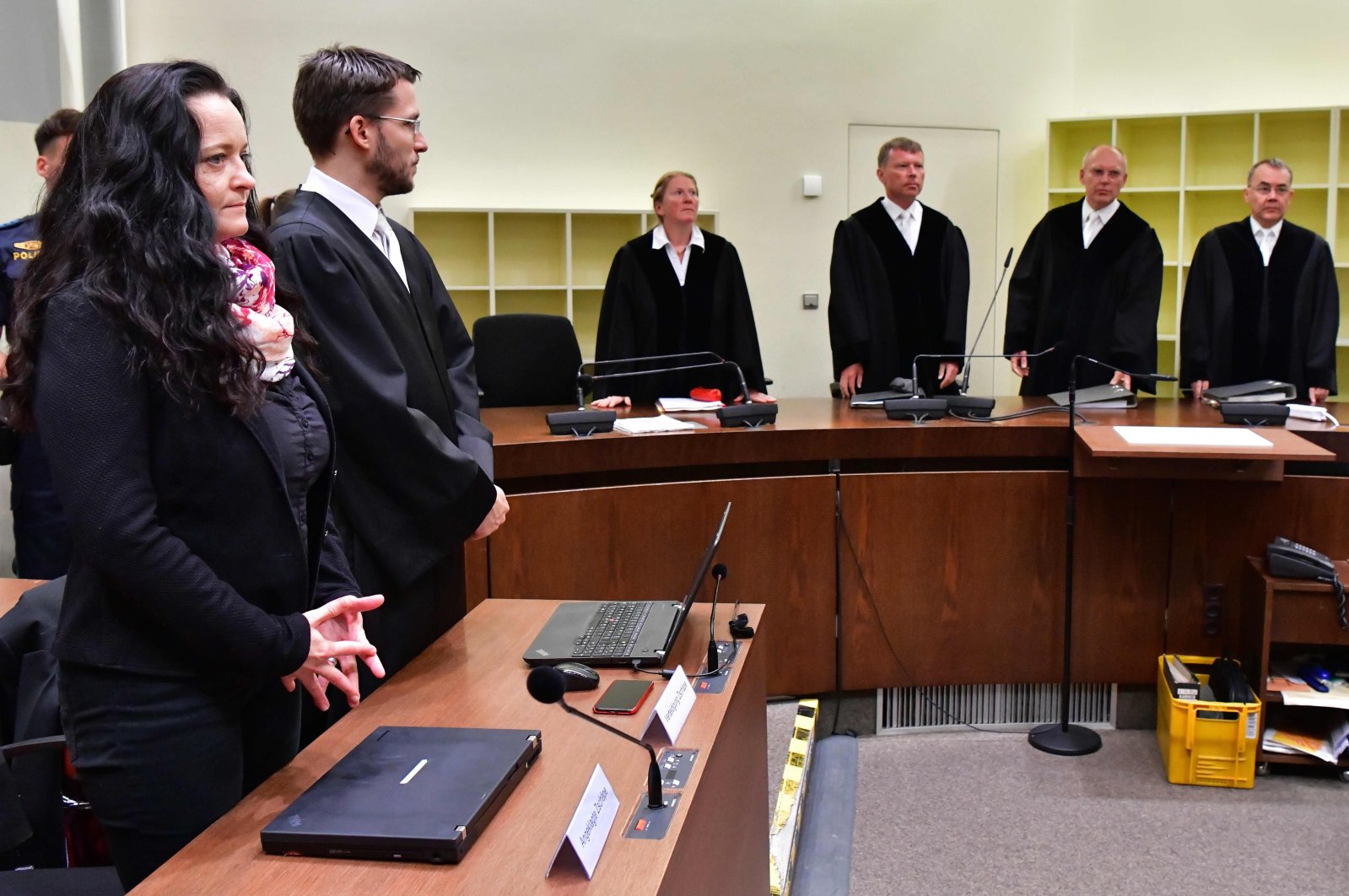 (L-R) Beate Zschaepe, her lawyer Mathias Grasel, judges Gabriele Feistkorn, Peter Lang, Manfred Goetzl and Konstantin Kuchenbauer stand before the proclamation of sentence in the trial against Beate Zschaepe, the only surviving member of the neo-Nazi cell National Socialist Underground (NSU) behind a string of racist murders, in Munich, Germany, July 11, 2018. (AFP Photo)