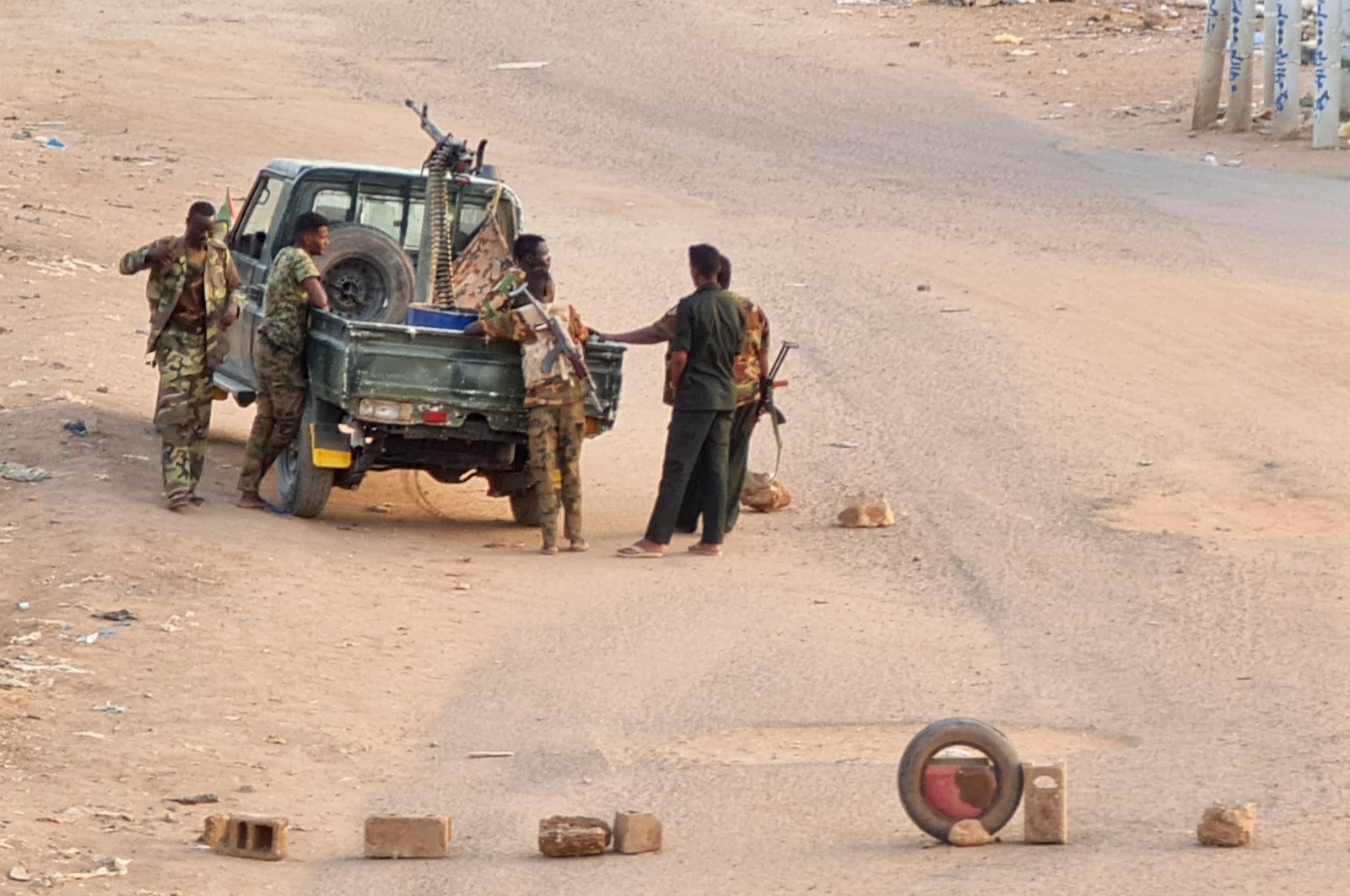 Sudanese army troops stand near their vehicle on a road in Khartoum, Sudan, May 20, 2023. (AFP Photo)