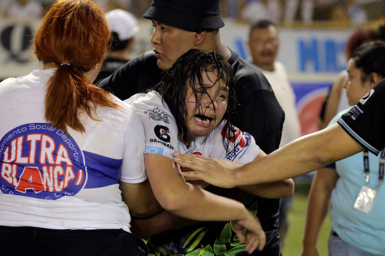 A woman is held by others as she cries following a stampede at a football match, San Salvador, El Salvador, May 20, 2023. (AFP Photo)