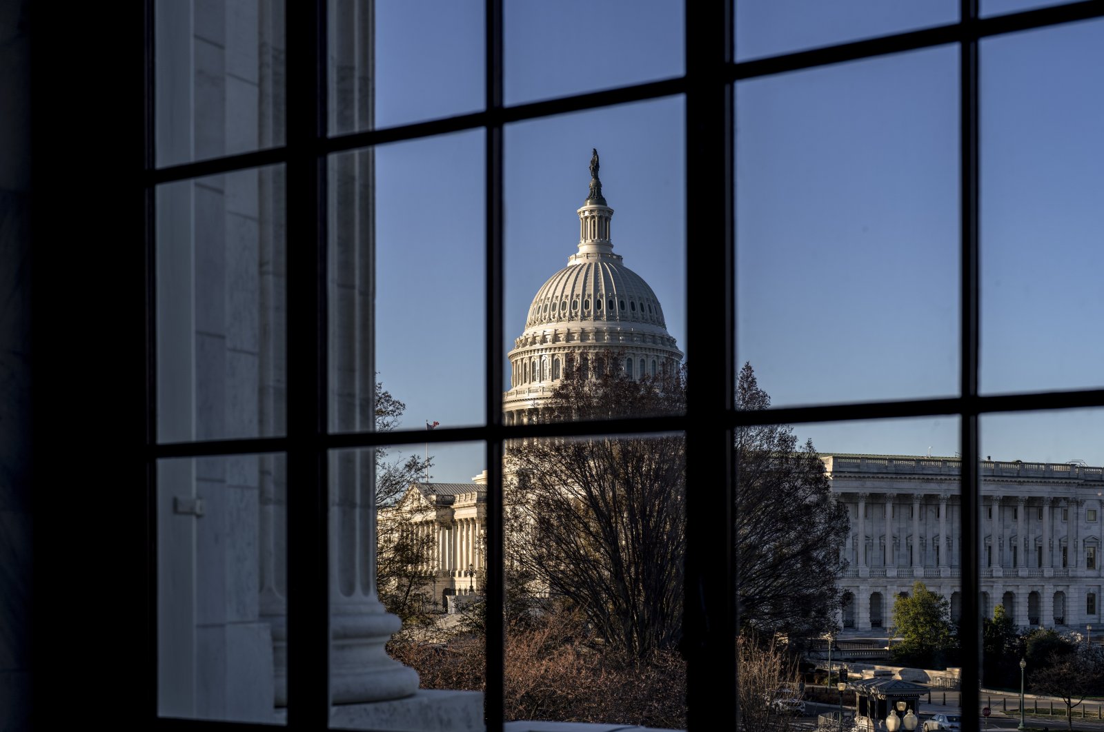 The U.S. Capitol seen through a window in the Russell Senate Office Building in Washington, U.S., March 15, 2023. (AP Photo)