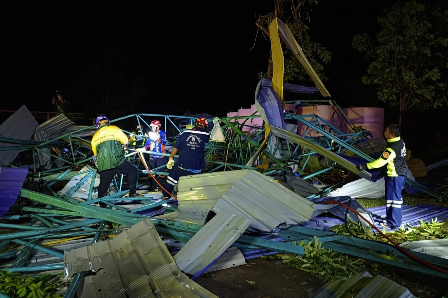 Thai rescuers at the scene of a collapsed metal roof, Phichit, northern Thailand, May 22, 2023. (AP Photo)