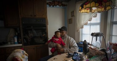 James Lyons kisses his grandson, Adrien Lyons, in the kitchen of his home in Birmingham, Alabama, U.S., Feb. 5, 2022. (AP Photo)