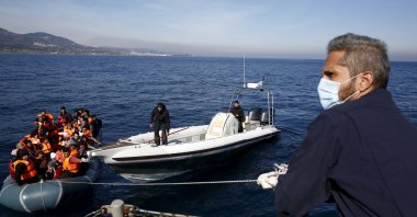 Greek Coast Guard officers tug a dinghy carrying refugees and migrants toward the Ayios Efstratios Coast Guard vessel, during a rescue operation in the open sea between the Turkish coast and the Greek island of Lesbos, Feb. 8, 2016. (Reuters File Photo)