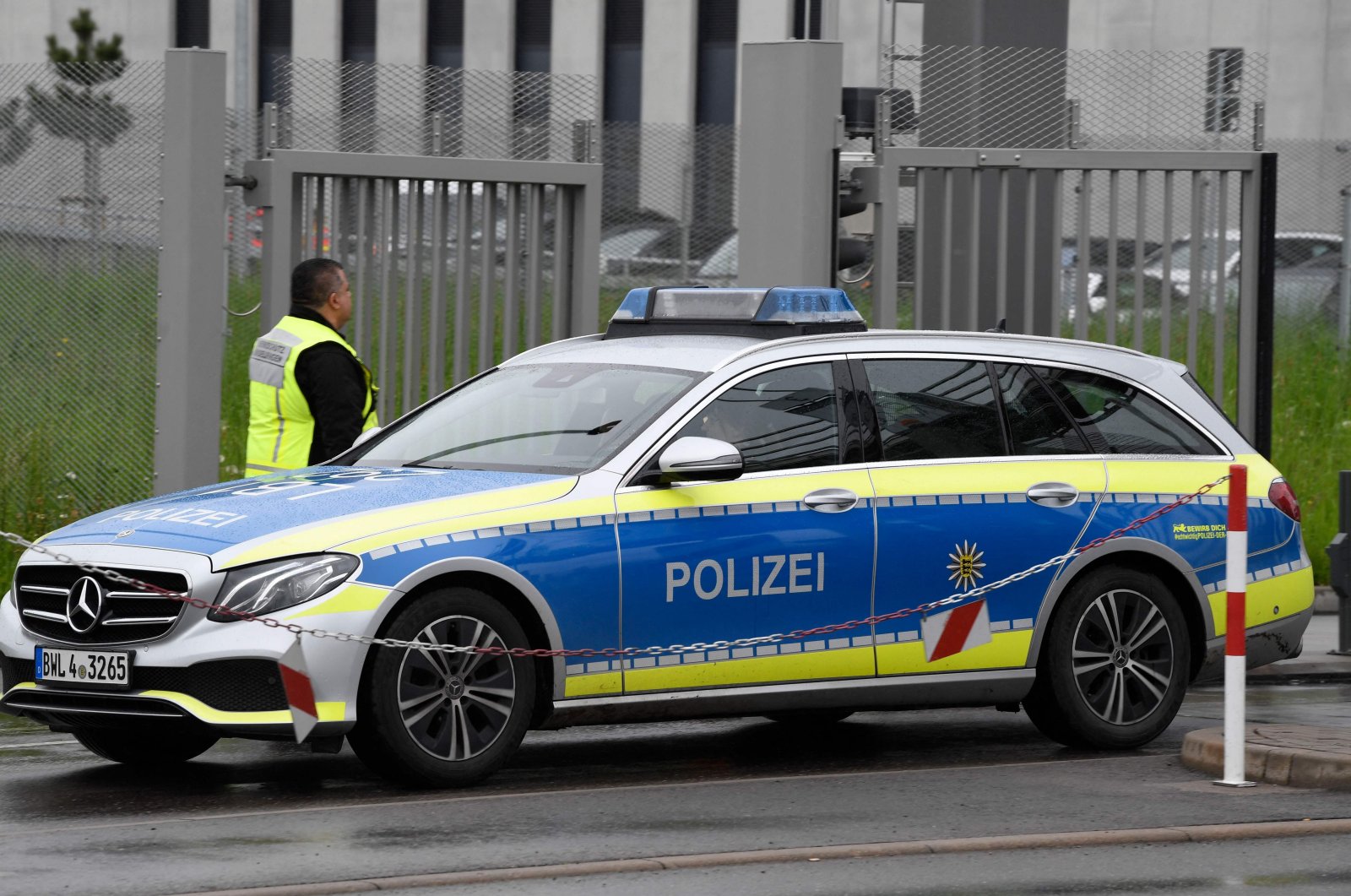 A police car leaves the grounds of Factory 56 at the plant of German car maker Mercedes-Benz in Sindelfingen, southern Germany after shots were fired at the plant on May 11, 2023. (AFP File Photo)
