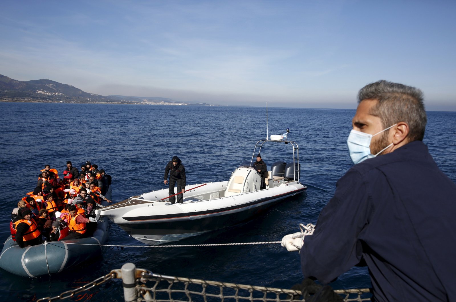Greek Coast Guard officers tug a dinghy carrying refugees and migrants toward the Ayios Efstratios Coast Guard vessel, during a rescue operation in the open sea between the Turkish coast and the Greek island of Lesbos, Feb. 8, 2016. (Reuters File Photo)