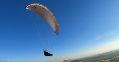 A paraglider is seen flying over the Karacadağ area in central Konya province, Türkiye, May 24, 2023. (AA Photo)