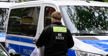 A Police officer carries a box of materials gathered during the search of a building in Berlin's Kreuzberg district in connection with the "Letzte Generation" (Last Generation) group on May 24, 2023. (AFP Photo)