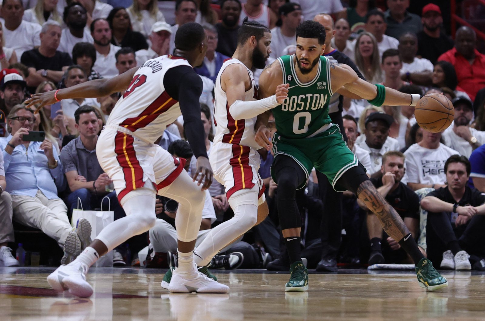 Boston Celtics&#039; Jayson Tatum (R) drives against Miami Heat players during the fourth quarter in game four of the Eastern Conference Finals at Kaseya Center, Miami, U.S., May 23, 2023. (AFP Photo)