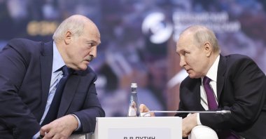 Russian President Vladimir Putin (R) and Belarusian President Alexander Lukashenko talk to each other during the plenary session of the Eurasian Economic Forum in Moscow, Russia, May 24, 2023. (AP Photo)