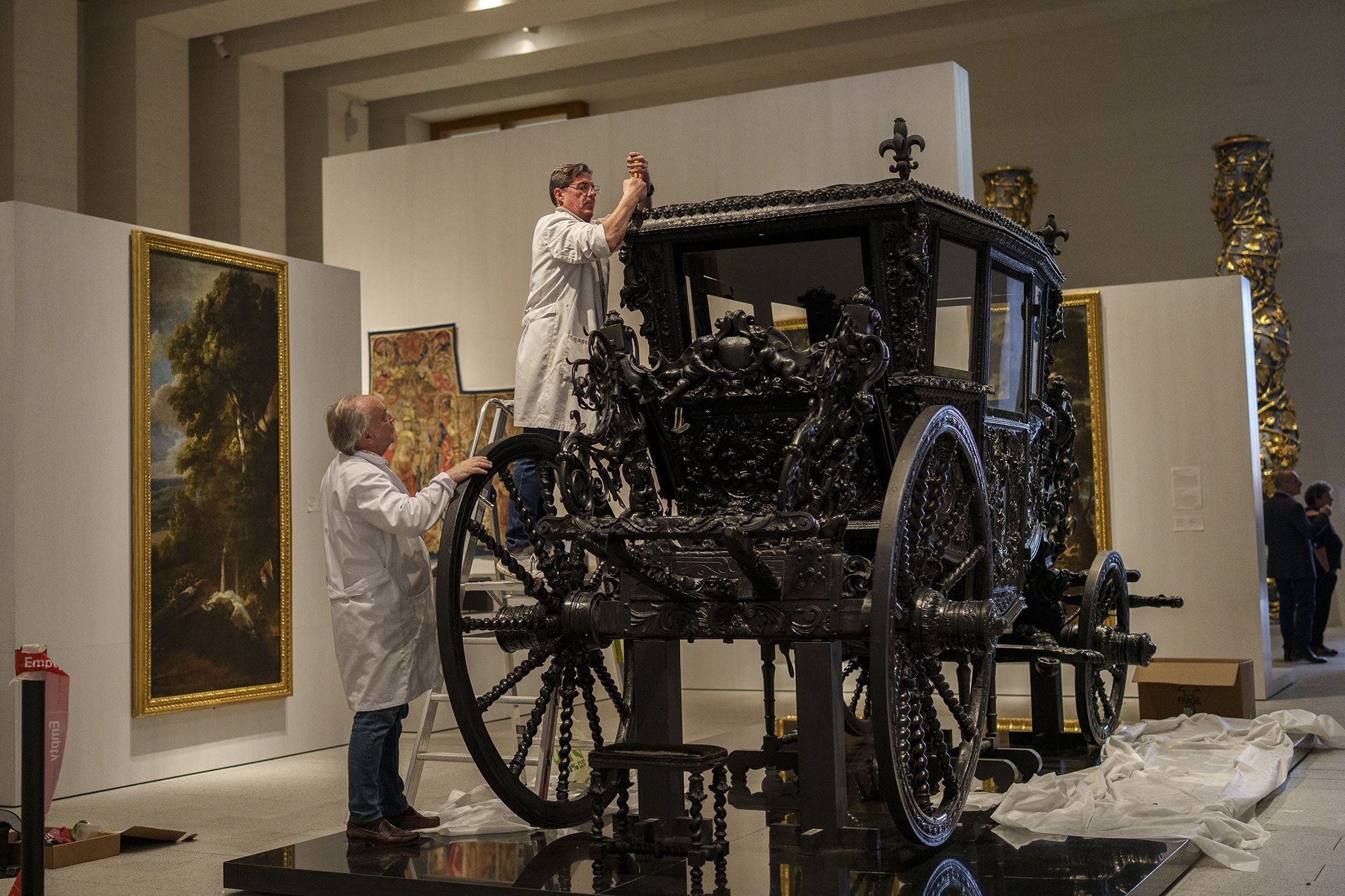 Staff members set up a royal carriage at the Royal Collections Gallery in Madrid, Spain, May. 19, 2023. (AP Photo)