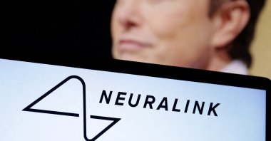Neuralink logo and Elon Musk photo are seen in this illustration taken, Dec.19, 2022. (Reuters Photo)
