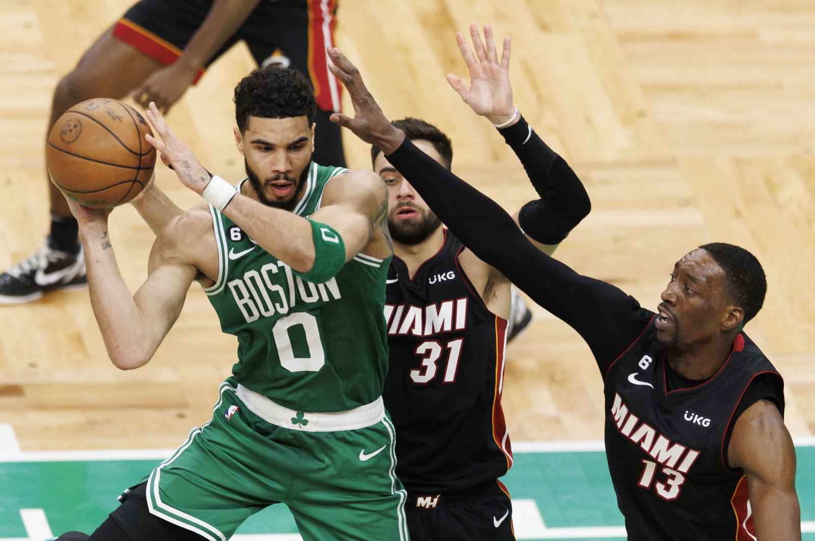 Boston Celtics forward Jayson Tatum (L) passes the ball as Miami Heat guard Max Strus (C) and Miami Heat center Bam Adebayo (R) defends during the third quarter of the Eastern Conference Finals playoff Game 5 at TD Garden in Boston, U.S., May 25, 2023. (EPA Photo)