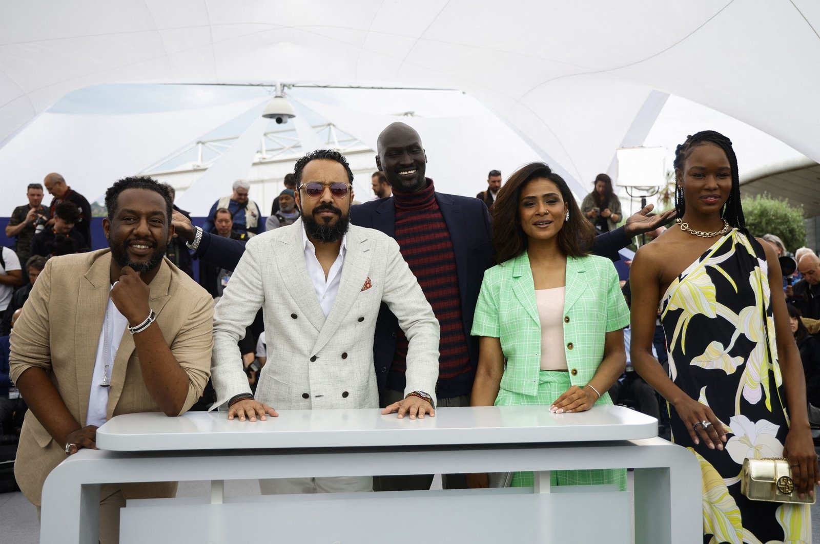 Director Mohamed Kordofani (C-L), along with cast and crew, pose for a photograph at the 76th Cannes Film Festival, in Cannes, France, May 21, 2023. (Reuters Photo)