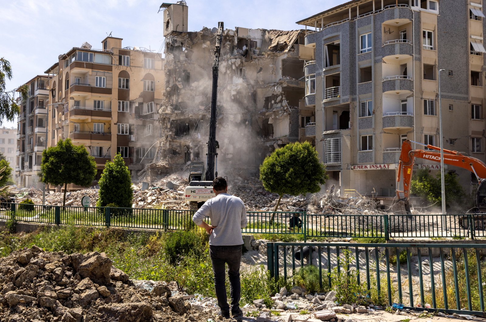 A man watches as excavators demolish a building in Antakya&#039;s city center, Hatay, Türkiye, May 4, 2023. (Reuters Photo)