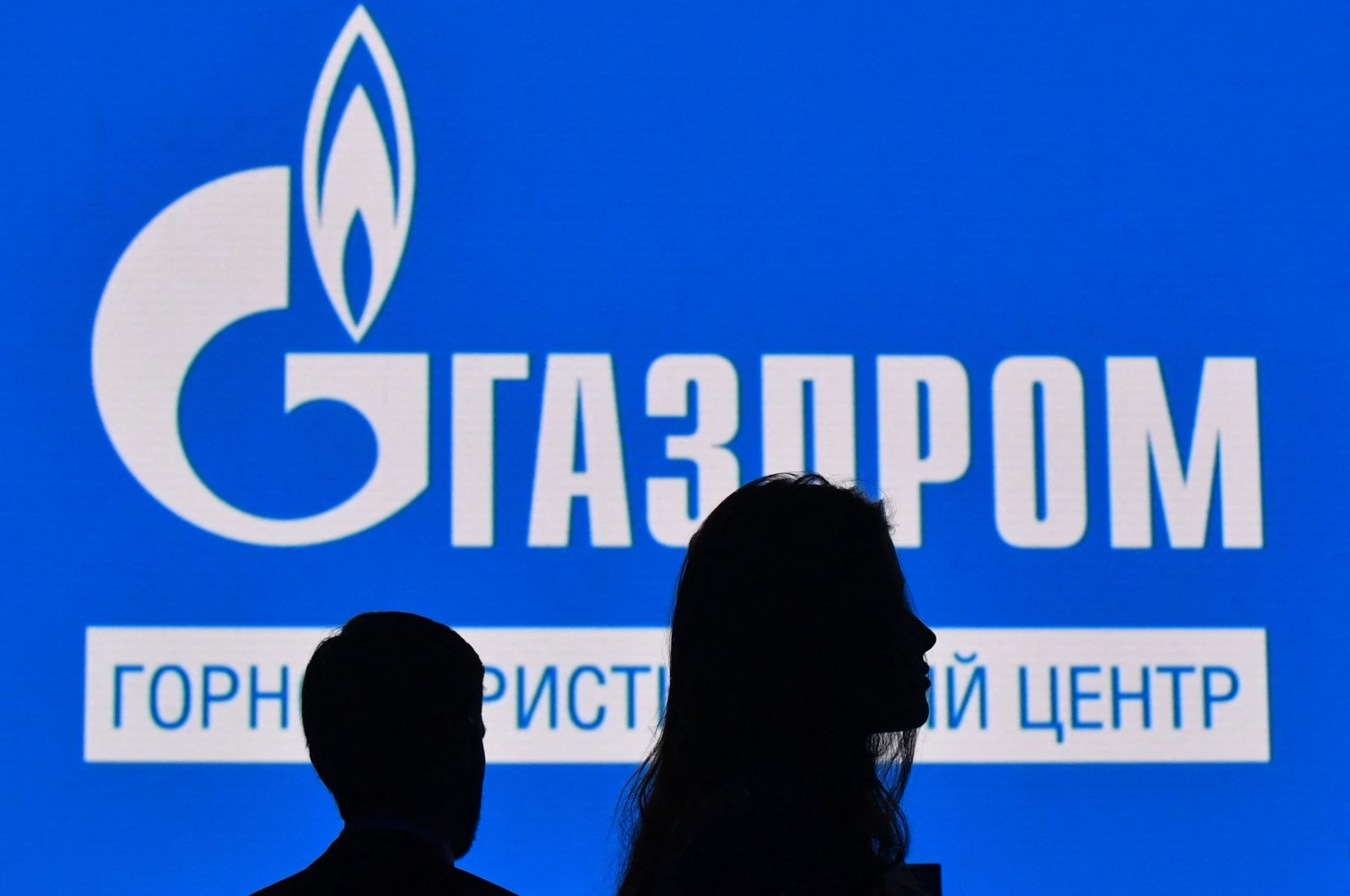Participants walk in front of a large screen displaying the logo of Russia&#039;s energy giant Gazprom during the St. Petersburg International Gas Forum (SPIGF) in Saint Petersburg, Russia, Sept. 15, 2022. (AFP Photo)