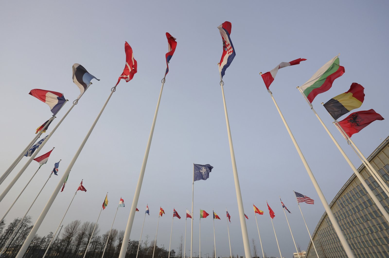 Flags of NATO members fly outside the NATO headquarters ahead of NATO Secretary General Jens Stoltenberg, European Commission President Ursula von der Leyen and European Council President Charles Michel signing a joint declaration on NATO-EU Cooperation at NATO headquarters in Brussels, Jan. 10, 2023. (AP File Photo)