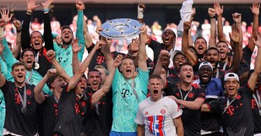 Bayern Munich players celebrate with the trophy after winning the Bundesliga, at RheinEnergieStadion, in Cologne, Germany, May 27, 2023. (Reuters Photo)