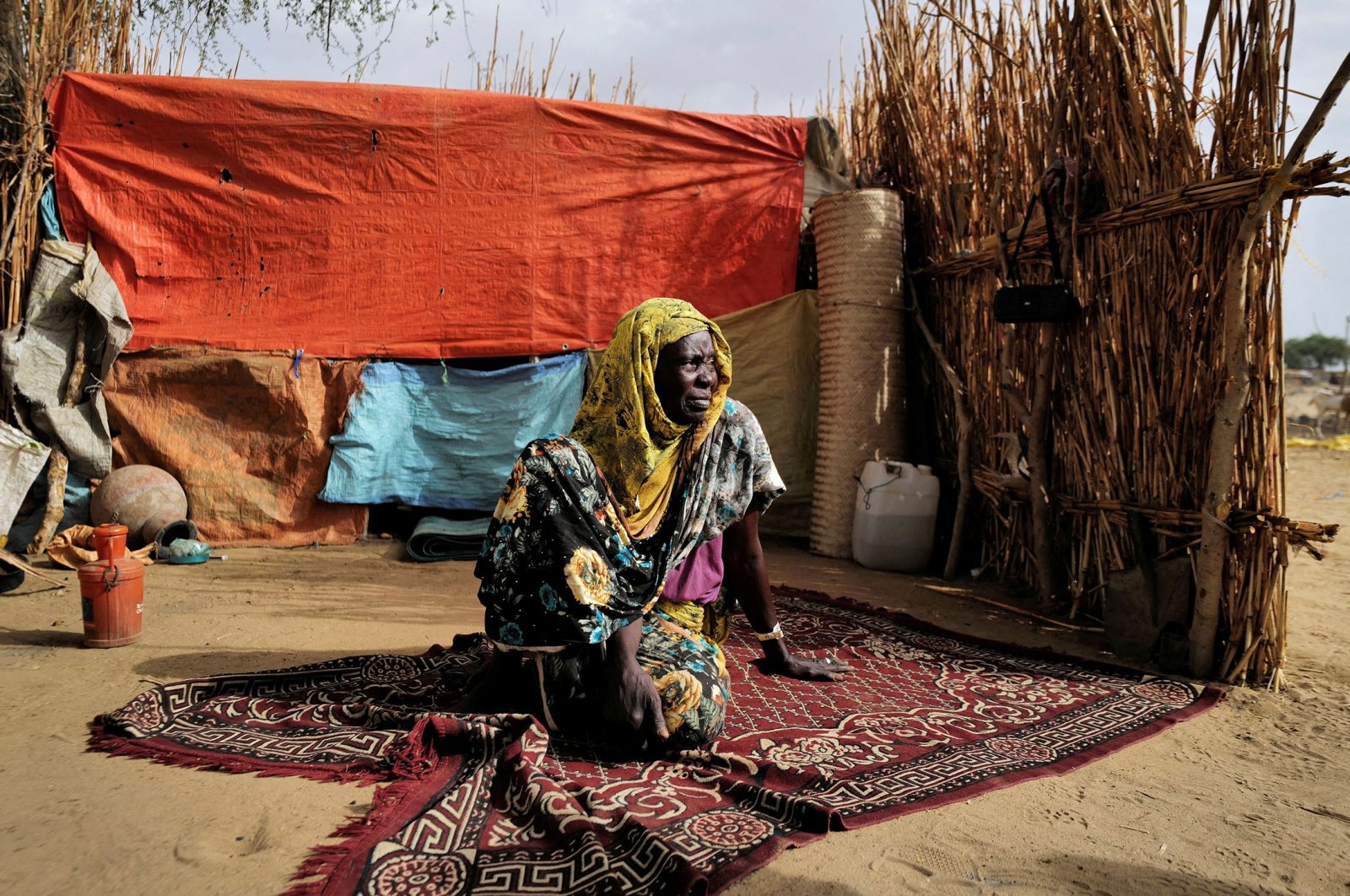 A Sudanese refugee who is seeking refuge in Chad for a second time, sits beside her shelter, near the border between Sudan and Chad in Koufroun, Chad, May 10, 2023. (Reuters Photo)
