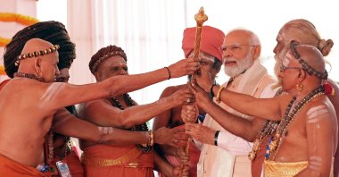 India's Prime Minister Narendra Modi (3R) holds the Sengol, a Tamil sceptre along with priests during the inauguration ceremony of the new parliament building, New Delhi, India, May 28, 2023. (AFP Photo)