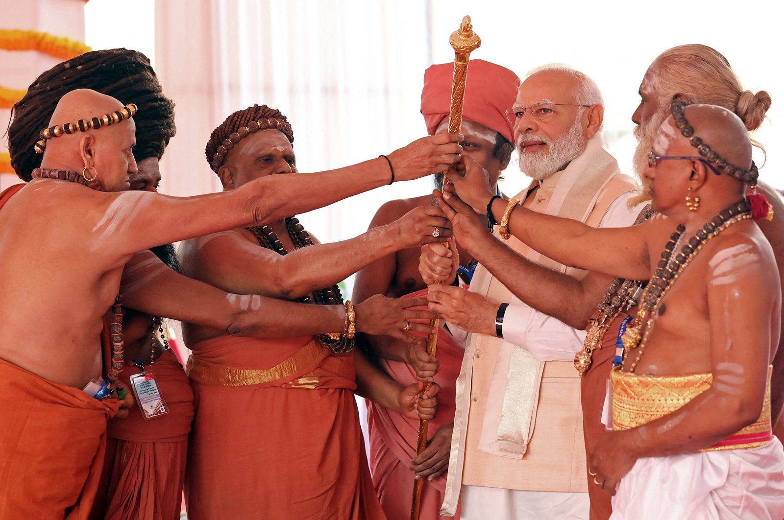 India&#039;s Prime Minister Narendra Modi (3R) holds the Sengol, a Tamil sceptre along with priests during the inauguration ceremony of the new parliament building, New Delhi, India, May 28, 2023. (AFP Photo)