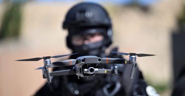 A member of France's Recherche, Assistance, Intervention, Dissuasion (RAID) flies a drone as he takes part in a demonstration at the Eurosatory international land and airland defence and security trade fair, Paris, France, June 12, 2022. (AFP Photo)