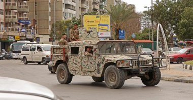 Soldiers ride an armored vehicle in Tripoli on April 26, 2023. (AFP File Photo)