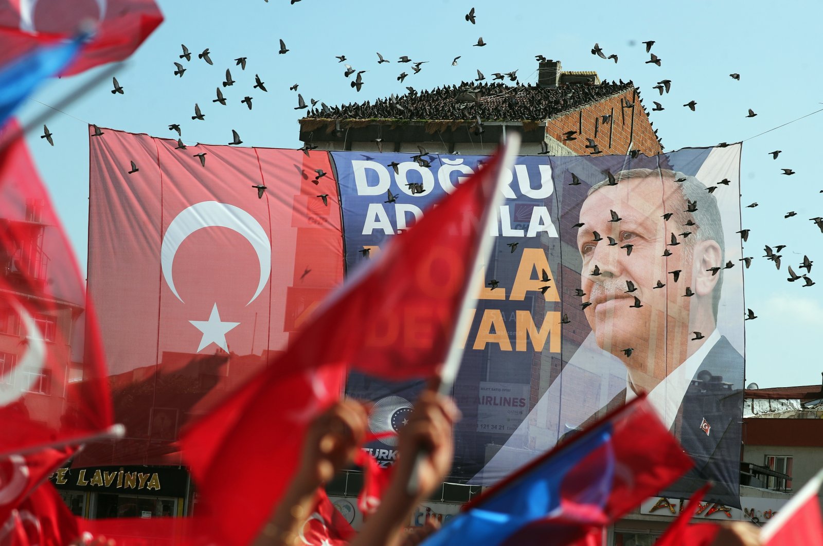 An election banner is seen as supporters of President Recep Tayyip Erdoğan gather for his election campaign rally prior to the second round of presidential elections in Istanbul, Türkiye, May 26, 2023. (EPA Photo)