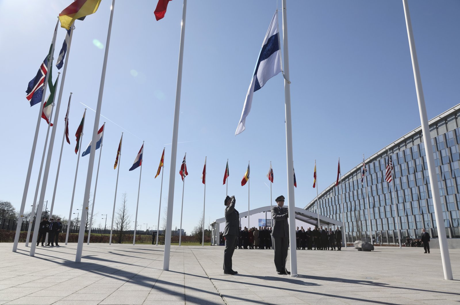 Military personnel raise the flag of Finland during a flag raising ceremony on the sidelines of a NATO foreign ministers meeting at NATO headquarters in Brussels, Tuesday, April 4, 2023. (AP File Photo)