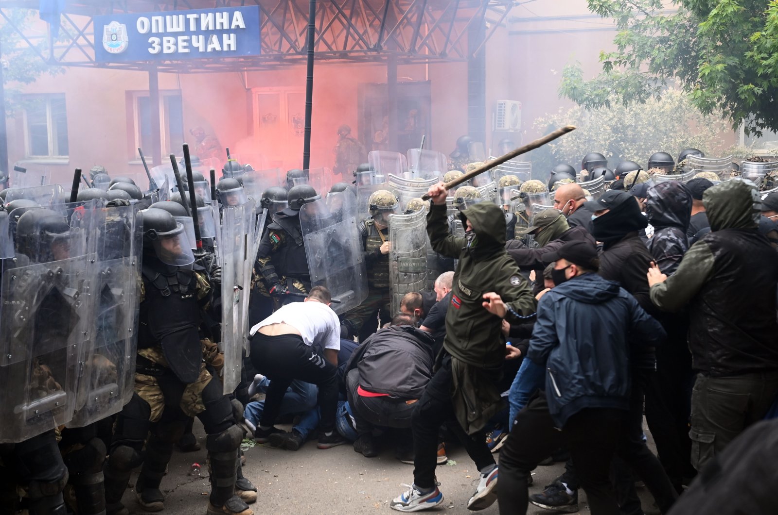 Soldiers of NATO-led international peacekeeping Kosovo Force (KFOR) scuffle with ethnic Serbs in front of the building of the municipality in Zvecan, Kosovo, May 29, 2023. (EPA Photo)