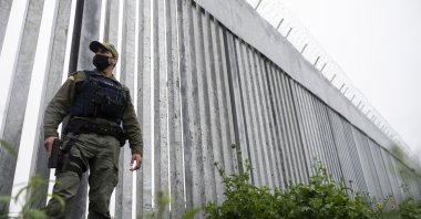A police officer patrols alongside a steel wall at Evros River, near the village of Poros, Greece, May 21, 2021. (AP Photo)