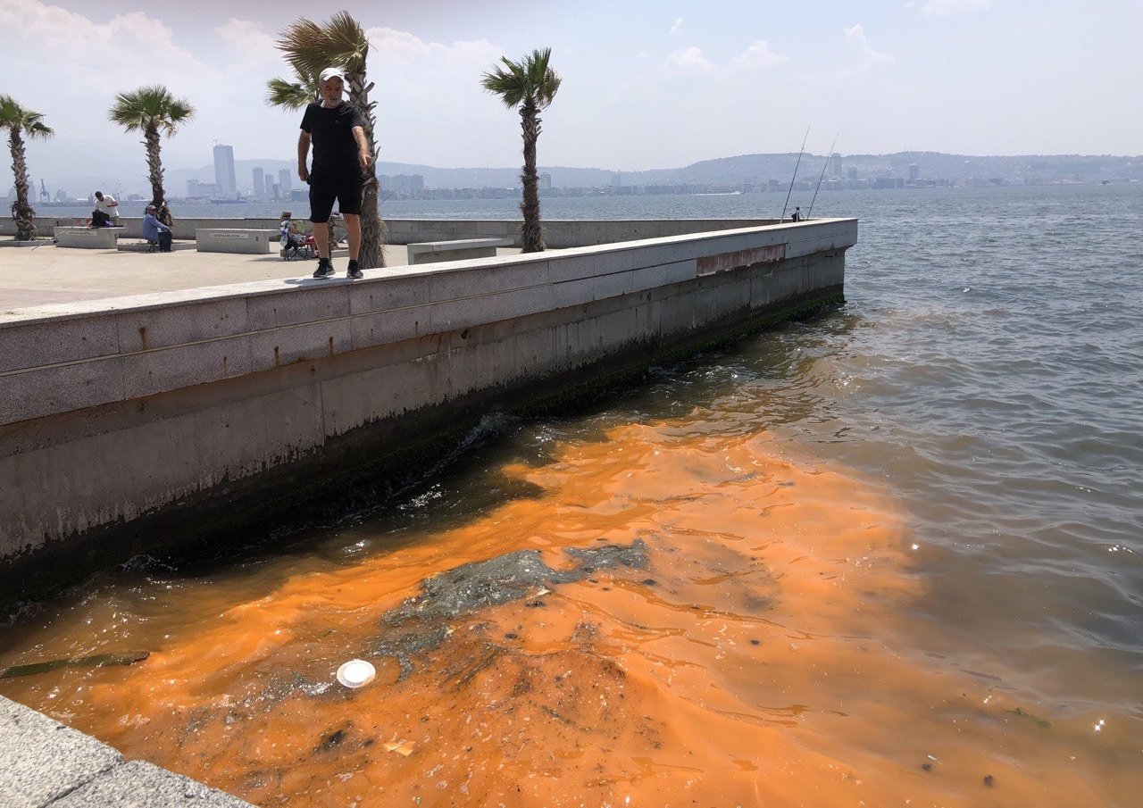 A significant color change, ranging from red to orange, caused by algae is seen in Izmir Bay, Türkiye, May 31, 2023. (DHA Photo)