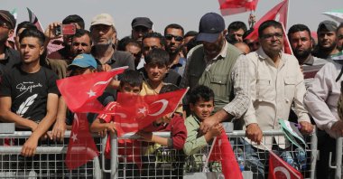 Syrians attend the inauguration of a Qatari-funded housing complex project Türkiye has launched for the internally displaced in the area of Ghandoura, in the countryside of Jarablus, northern Syria, on May 24, 2023. (AFP Photo)